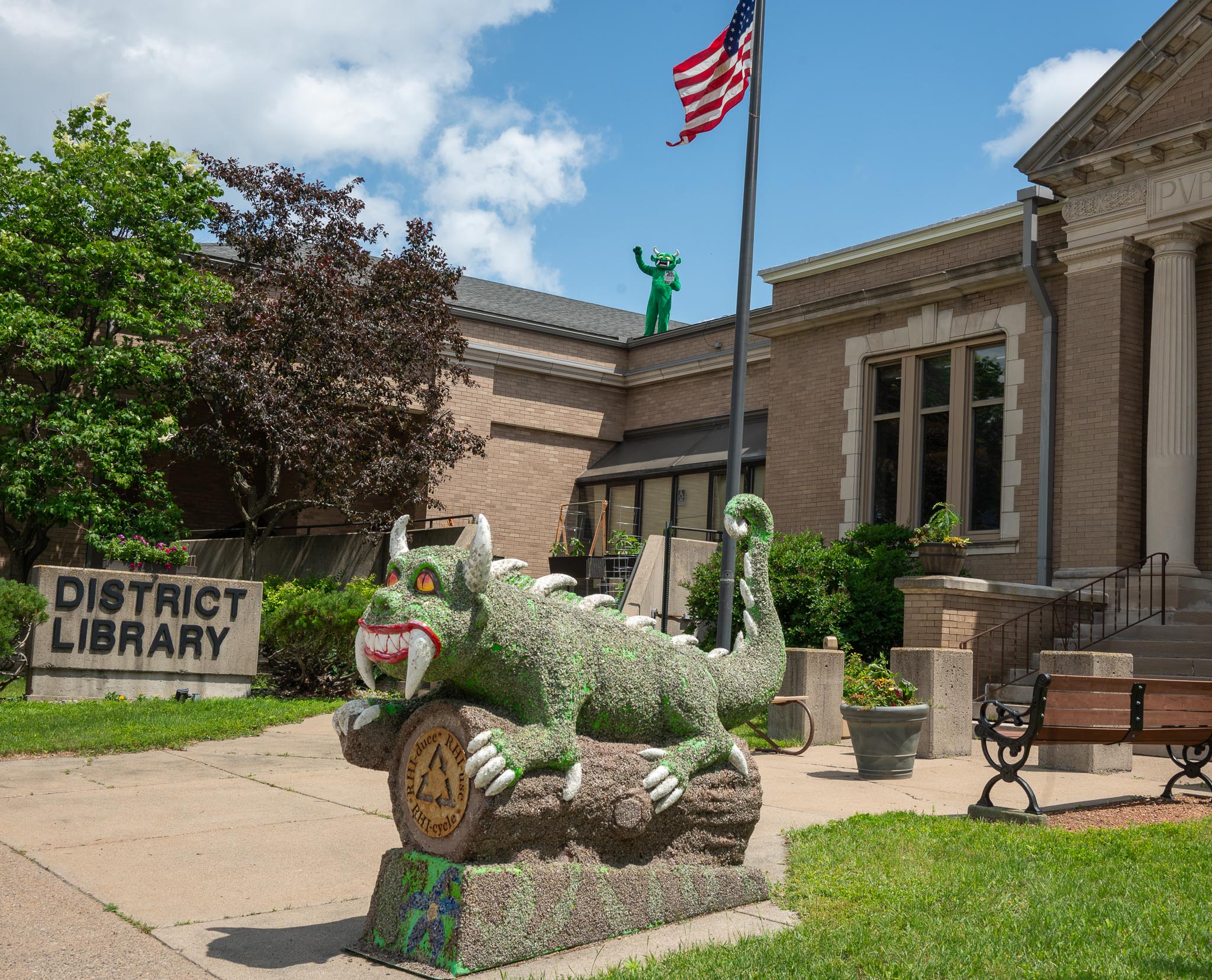 Person in Hodag suit on top of Rhinelander Library Roof