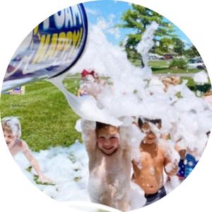 Foam Zone text on foam cannon shooting foam at kids with happy faces